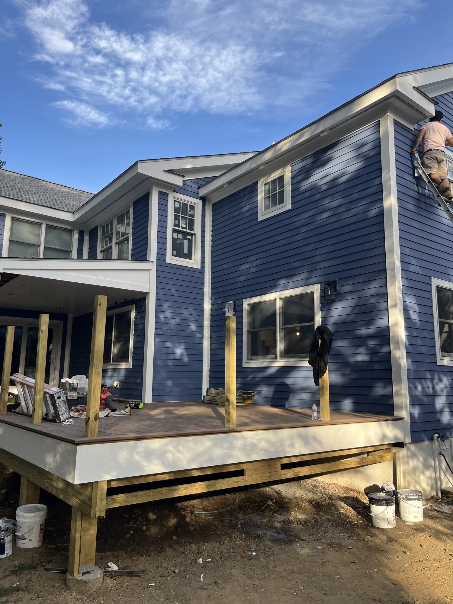 New rear covered porch and deck framing under construction